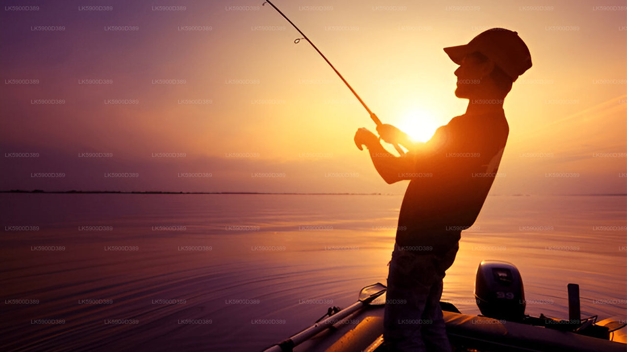 Person fishing on a boat at sunset.