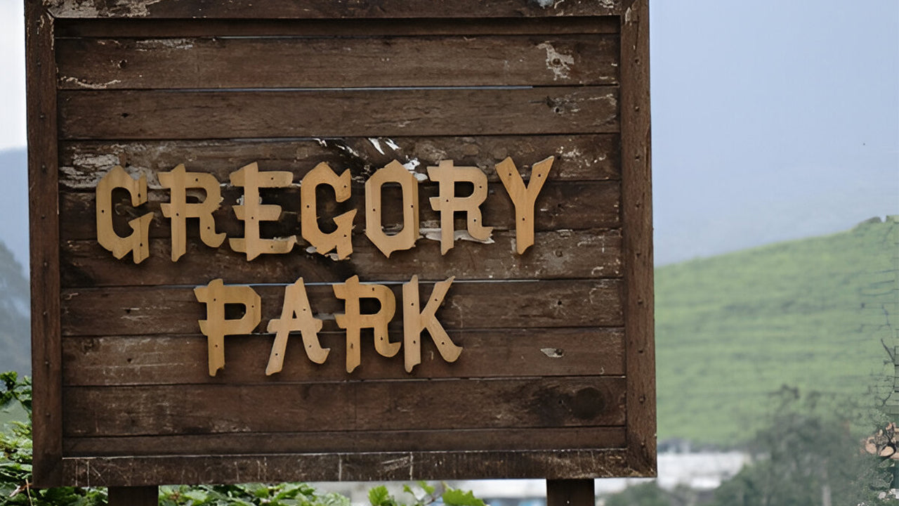 Wooden sign with 'Gregory Park' text against a natural background