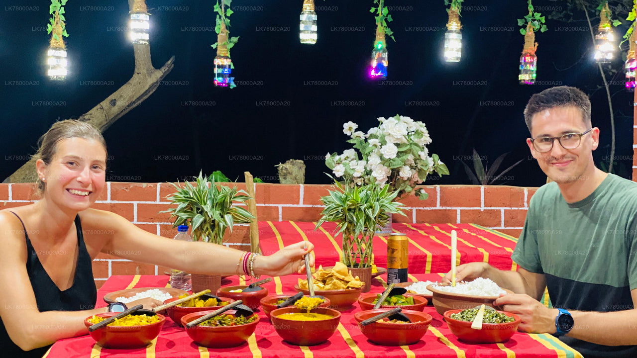 Two people enjoying a meal together at an outdoor setting with string lights and flowers.
